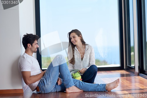 Image of relaxed young couple at home staircase