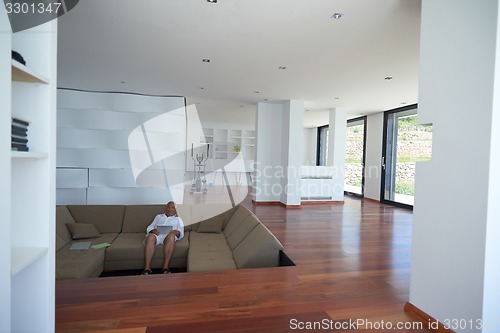 Image of Portrait of senior man relaxing in sofa