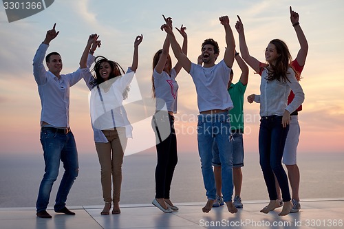 Image of party people  on sunset