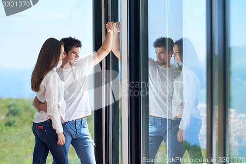 Image of relaxed young couple at home staircase