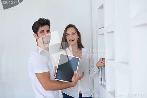 Image of relaxed young couple at home staircase