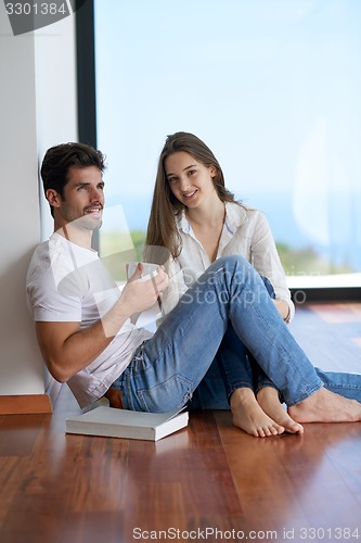 Image of relaxed young couple at home staircase