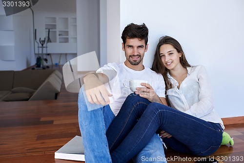 Image of relaxed young couple at home staircase