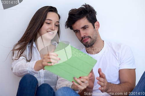 Image of couple at modern home using tablet computer
