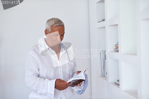 Image of Portrait of senior man relaxing in sofa