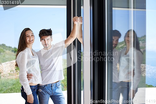 Image of relaxed young couple at home staircase