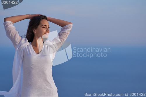 Image of young woman enjoy sunset