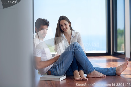 Image of relaxed young couple at home staircase