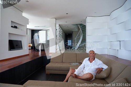 Image of Portrait of senior man relaxing in sofa