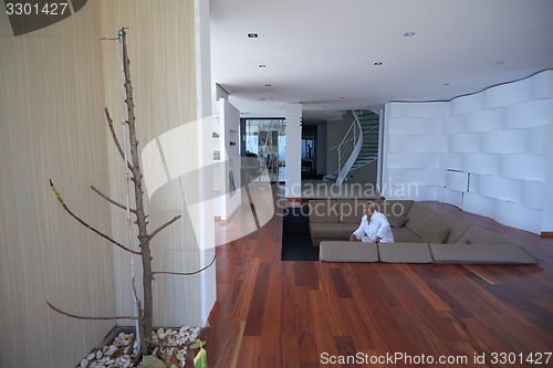 Image of Portrait of senior man relaxing in sofa