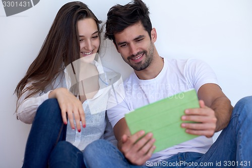 Image of couple at modern home using tablet computer