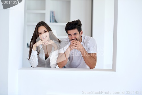 Image of relaxed young couple at home staircase