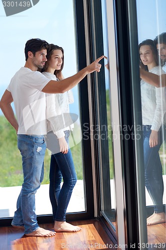 Image of relaxed young couple at home staircase