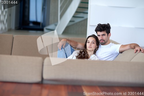 Image of relaxed young couple at home staircase