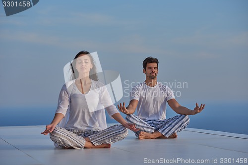 Image of young couple practicing yoga