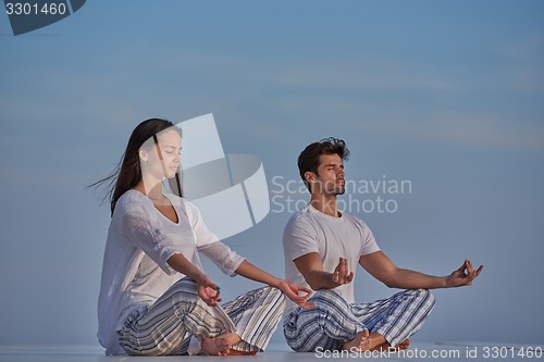 Image of young couple practicing yoga