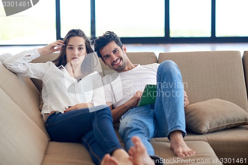 Image of couple at modern home using tablet computer