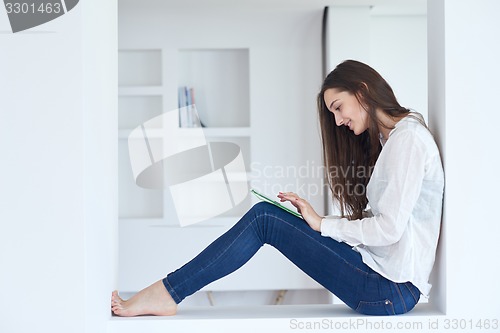 Image of woman at home using tablet