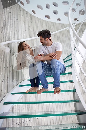 Image of relaxed yung couple at home  stairs