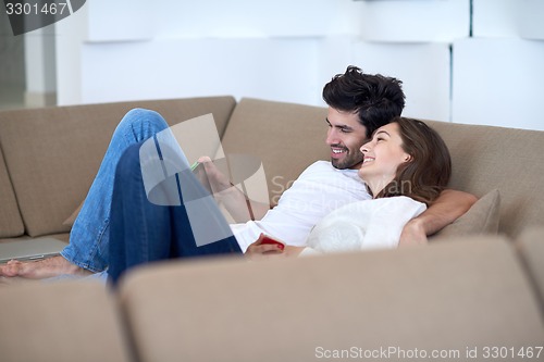 Image of couple at modern home using tablet computer