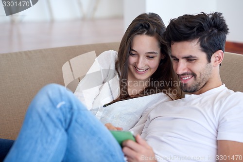 Image of couple at modern home using tablet computer