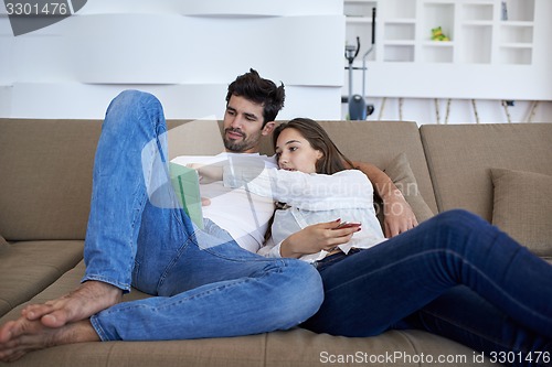 Image of couple at modern home using tablet computer