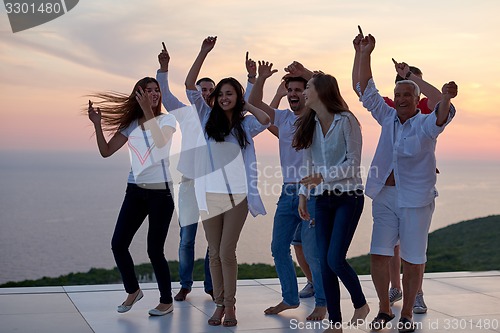 Image of party people  on sunset