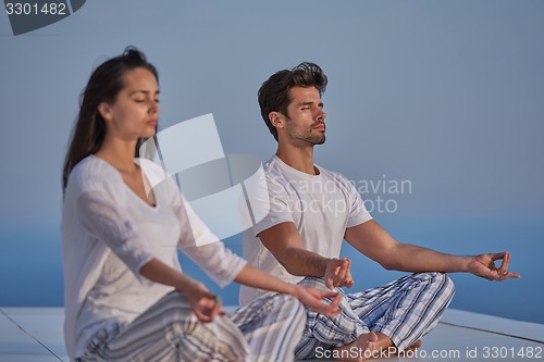 Image of young couple practicing yoga