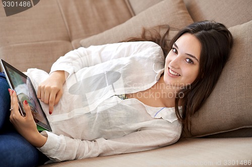 Image of woman at home using tablet