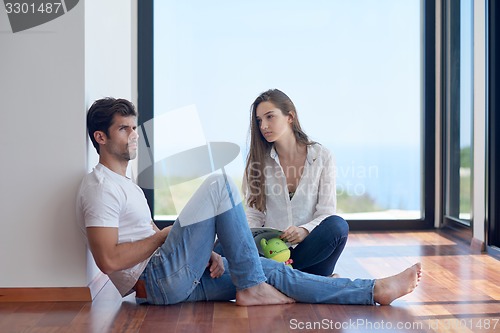 Image of relaxed young couple at home staircase