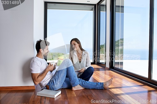 Image of relaxed young couple at home staircase