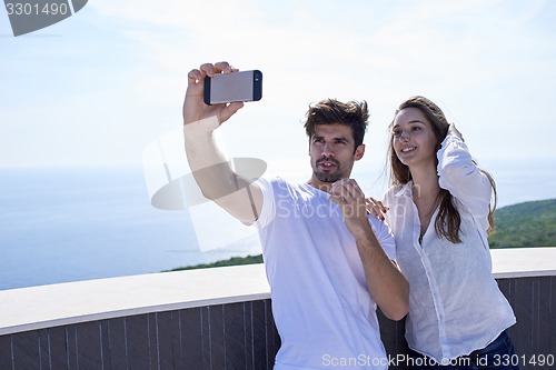 Image of young couple making selfie together
