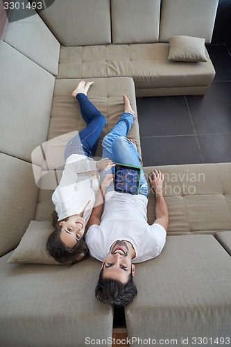 Image of couple at modern home using tablet computer
