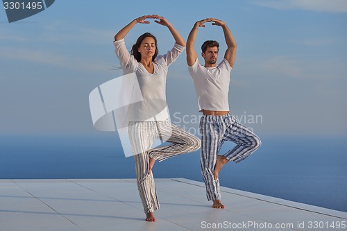 Image of young couple practicing yoga