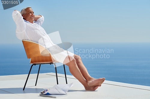 Image of senior man sitting outside