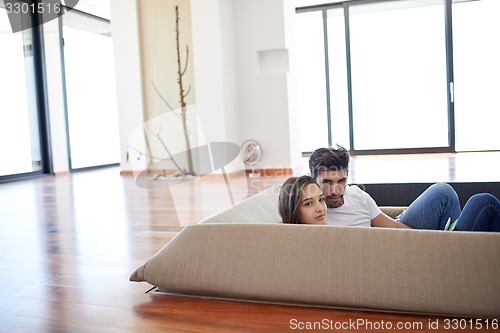 Image of relaxed young couple at home staircase