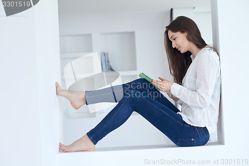 Image of woman at home using tablet