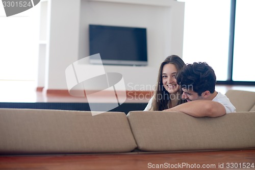 Image of relaxed young couple at home staircase