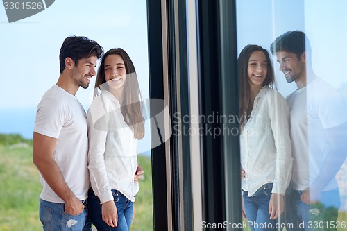 Image of relaxed young couple at home staircase