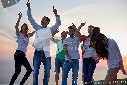 Image of party people  on sunset