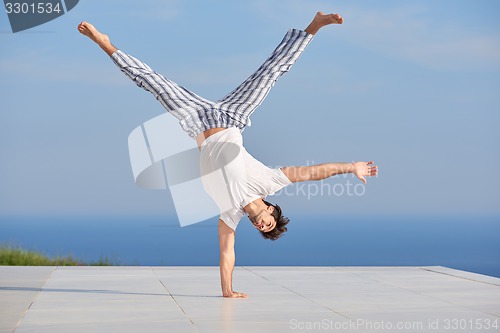 Image of young man practicing yoga