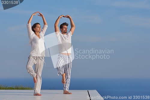 Image of young couple practicing yoga