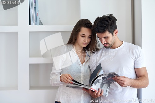 Image of relaxed young couple at home staircase