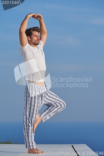 Image of young man practicing yoga