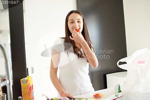 Image of Young Woman Cooking in the kitchen