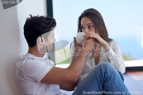Image of relaxed young couple at home staircase