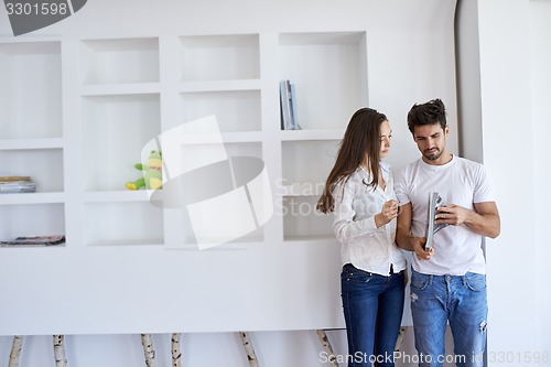 Image of relaxed young couple at home staircase