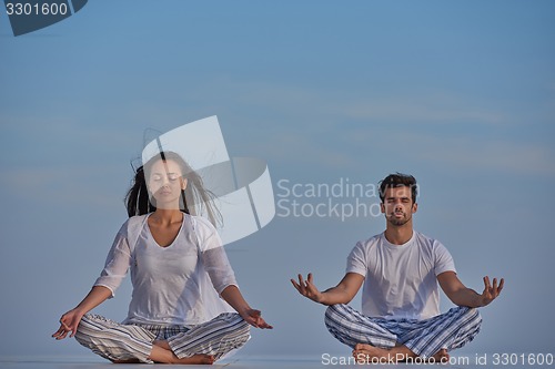 Image of young couple practicing yoga