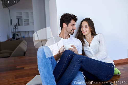 Image of relaxed young couple at home staircase