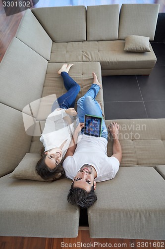 Image of couple at modern home using tablet computer